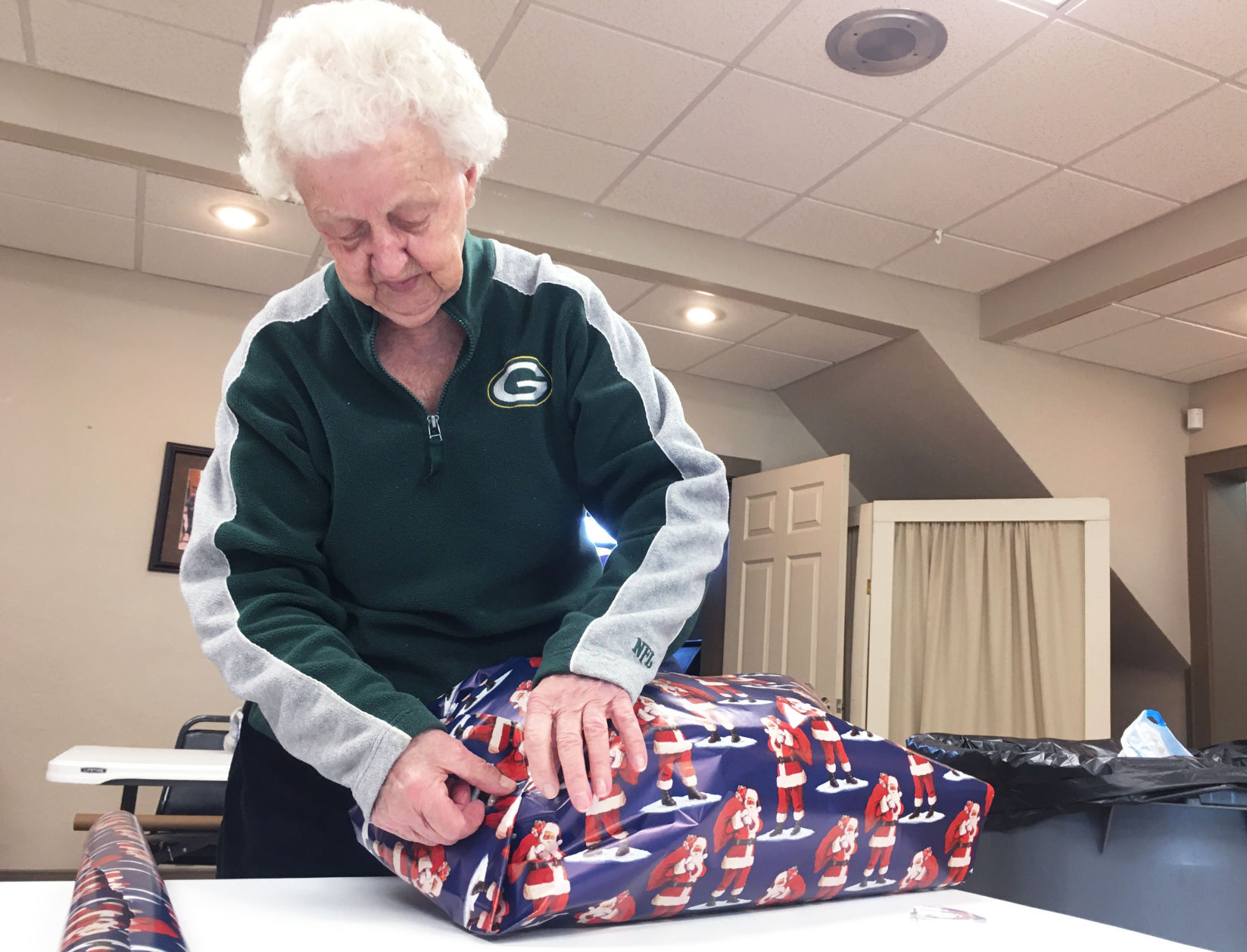 Bernice Steffens wraps a gift for veterans home residents during holiday season